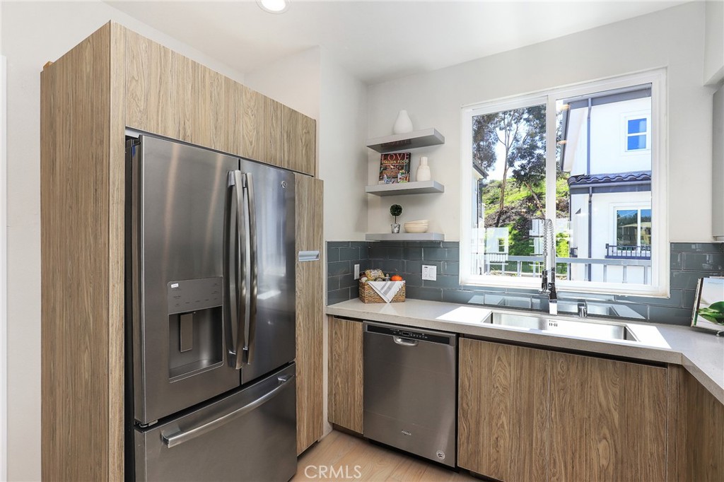 8 Brookline Way Phillips Ranch, CA 91766 - Photo 17 of 63 a kitchen with granite countertop a refrigerator and a sink