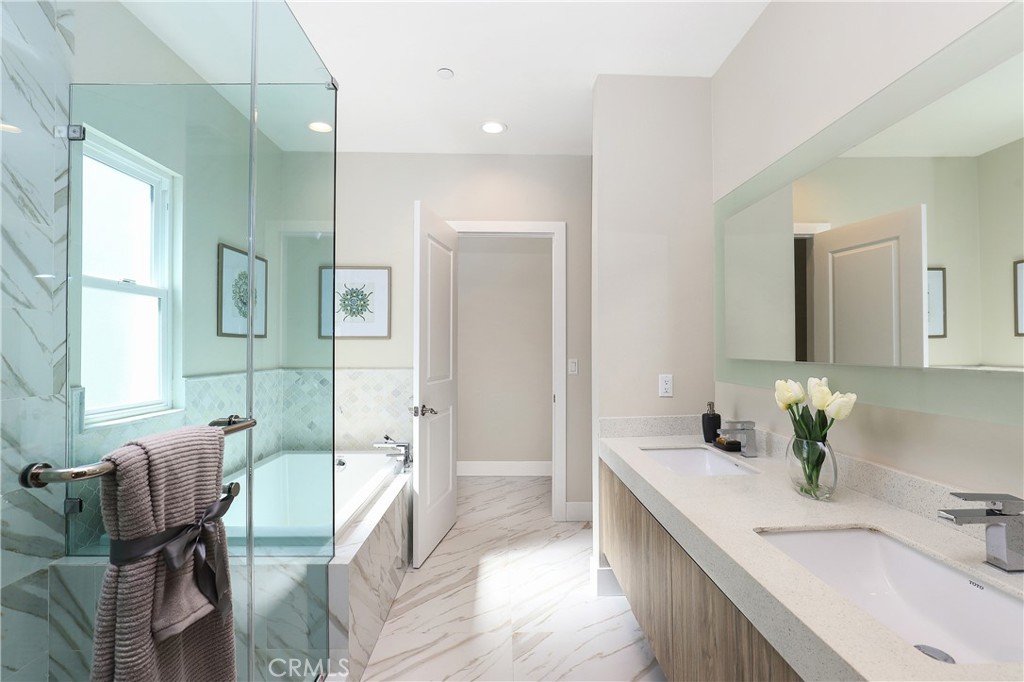 8 Brookline Way Phillips Ranch, CA 91766 - Photo 42 of 63 a spacious bathroom with a granite countertop tub sink and mirror