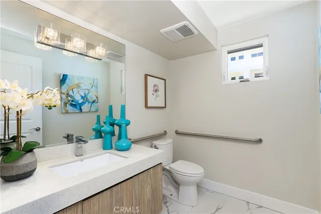 a living room with furniture and a view of kitchen