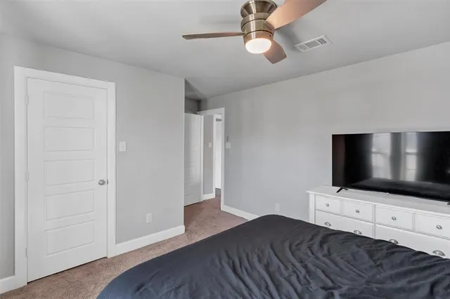 a bedroom with a bed and a dresser