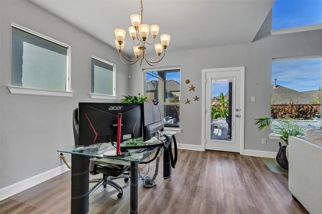 a kitchen with cabinets appliances and a dining table