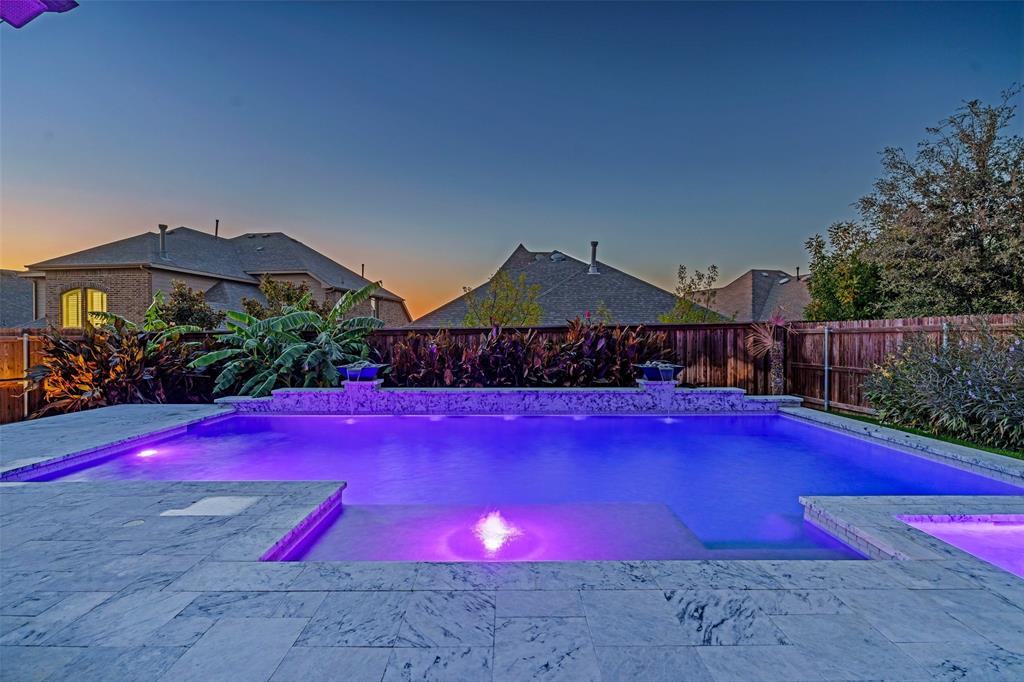 7500 Foxgrass Place Fort Worth, TX 76123 - Photo 5 of 29 a view of a yard with table and chairs under an umbrella