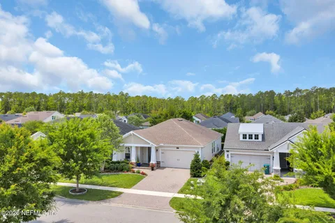 an aerial view of multiple houses with yard