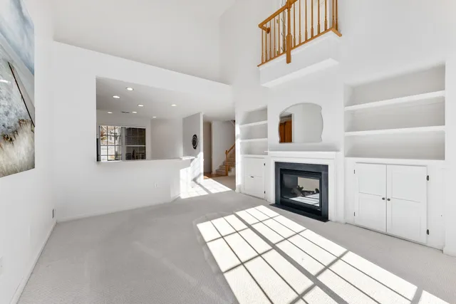 a view of a livingroom with an empty space and a fireplace