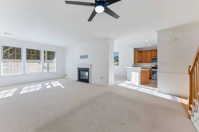 a view of empty room with a fireplace and window