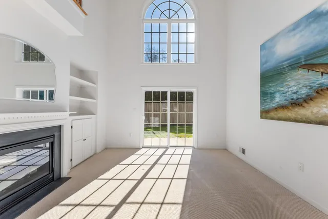 a view of an empty room with glass door