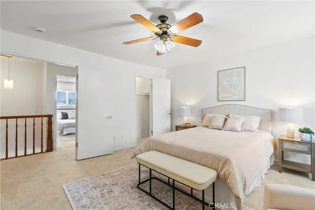 a bedroom with a bed a window and a chandelier