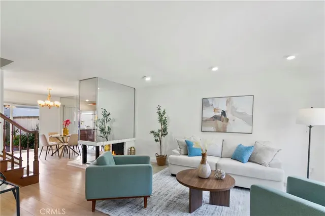 a living room with furniture and a view of kitchen