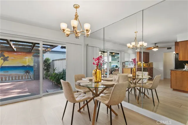 a view of a dining room with furniture wooden floor and chandelier