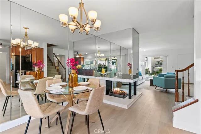 a view of a dining room with furniture wooden floor and chandelier