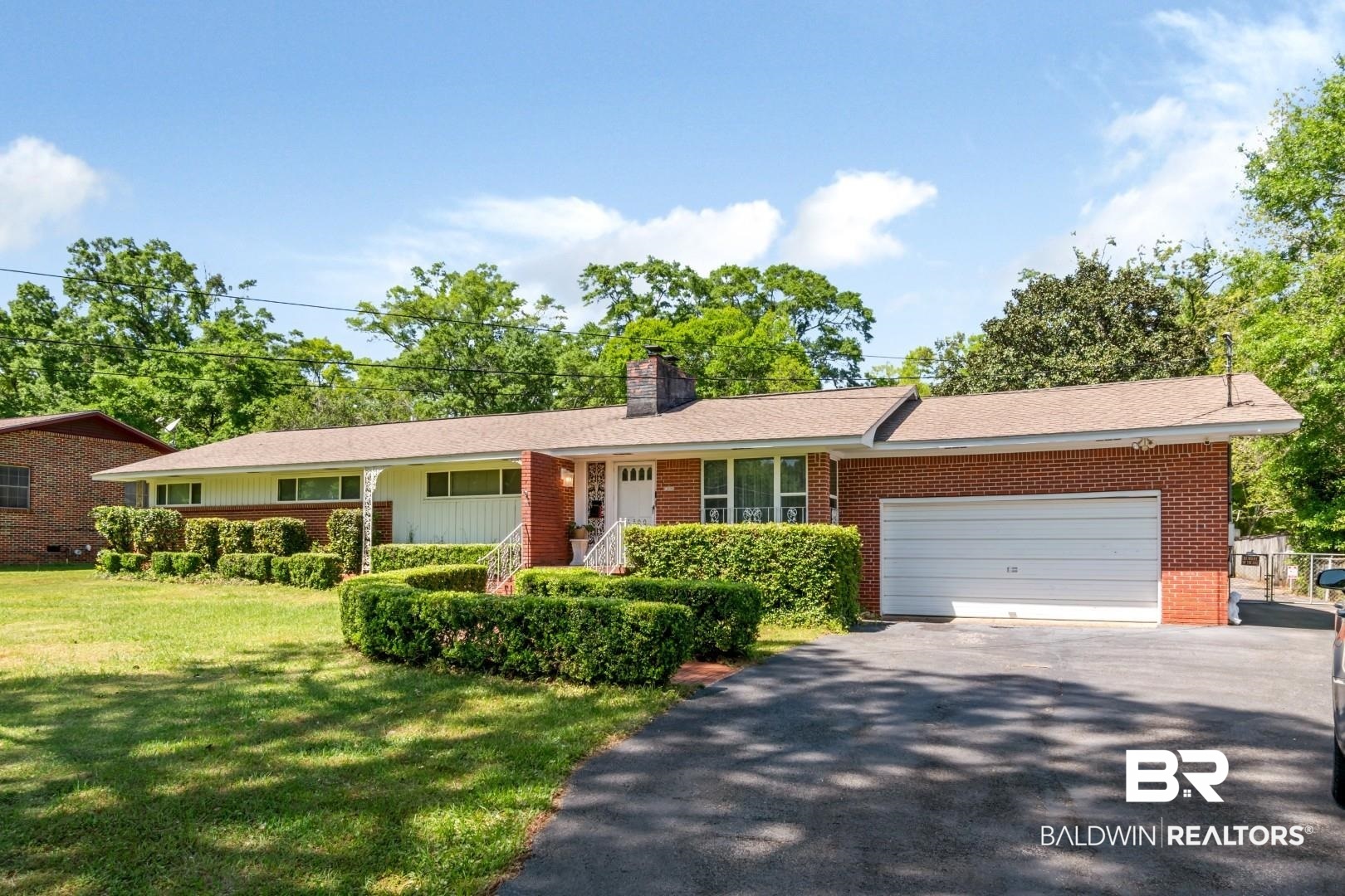6300 Woodcrest Drive Mobile, AL 36608 - Photo 1 of 35 Ranch-style home featuring an attached garage, aphalt driveway, a front yard, and brick siding