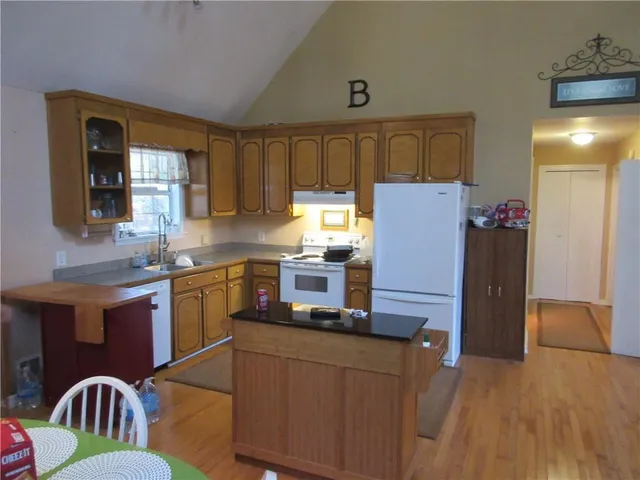 a kitchen with refrigerator and cabinets