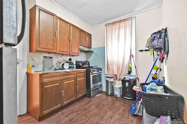 a kitchen with stainless steel appliances granite countertop a refrigerator and a sink