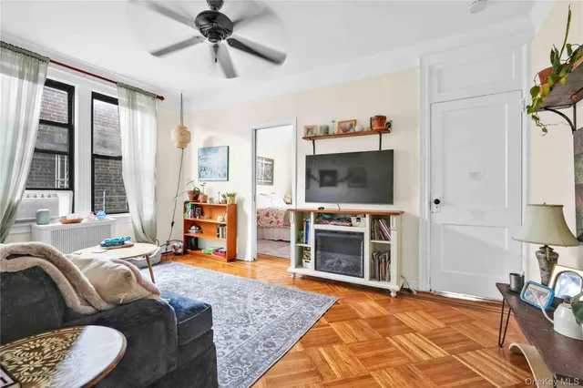 a bedroom with furniture and a flat screen tv