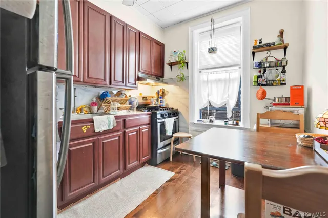 a kitchen with stainless steel appliances granite countertop a refrigerator sink and stove