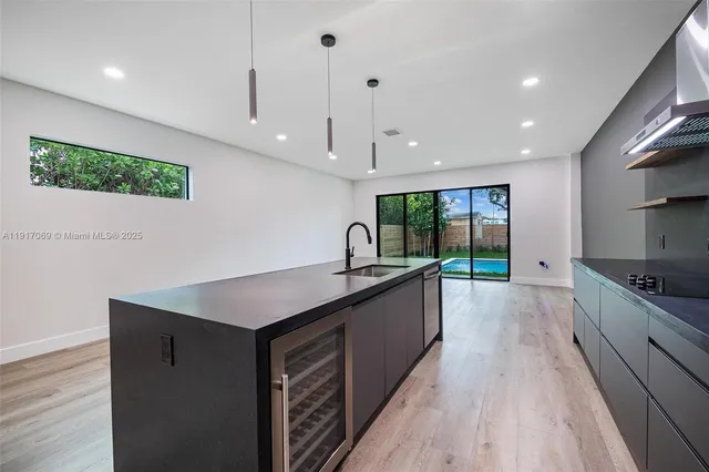 a view of kitchen with cabinets and wooden floor