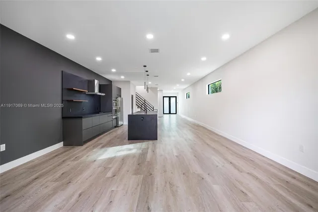 a living room with hard wood floors and a wooden floor