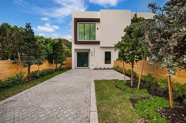 a front view of a house with a yard and garage