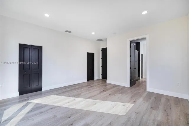 a bathroom with a granite countertop toilet sink and mirror