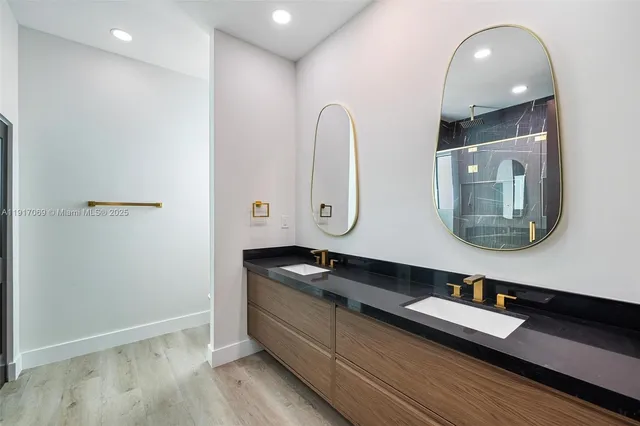 a bathroom with a glass shower door