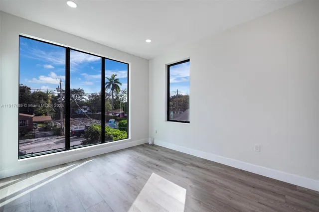 a view of a room with wooden floor
