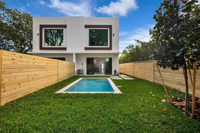 a view of a backyard with plants and a patio