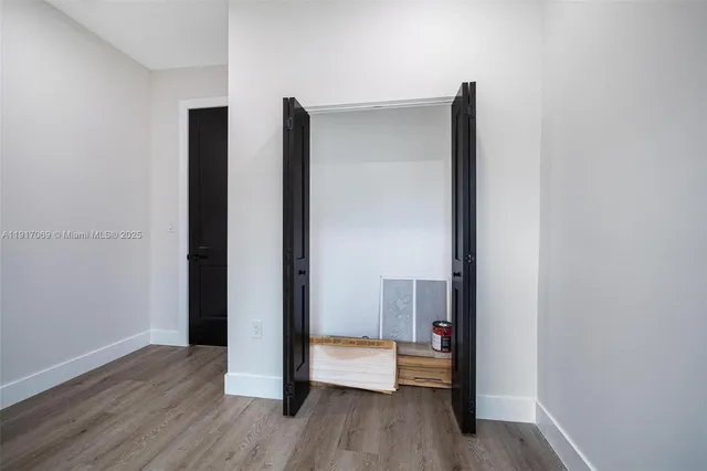 a view of hallway with wooden floor