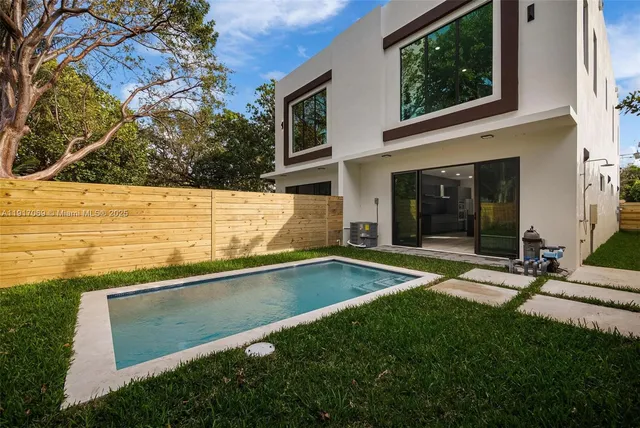 a view of house with yard and glass windows