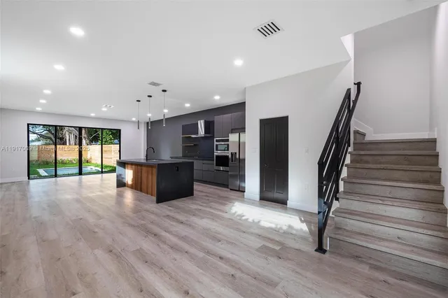 a view of kitchen with stainless steel appliances refrigerator stove and microwave