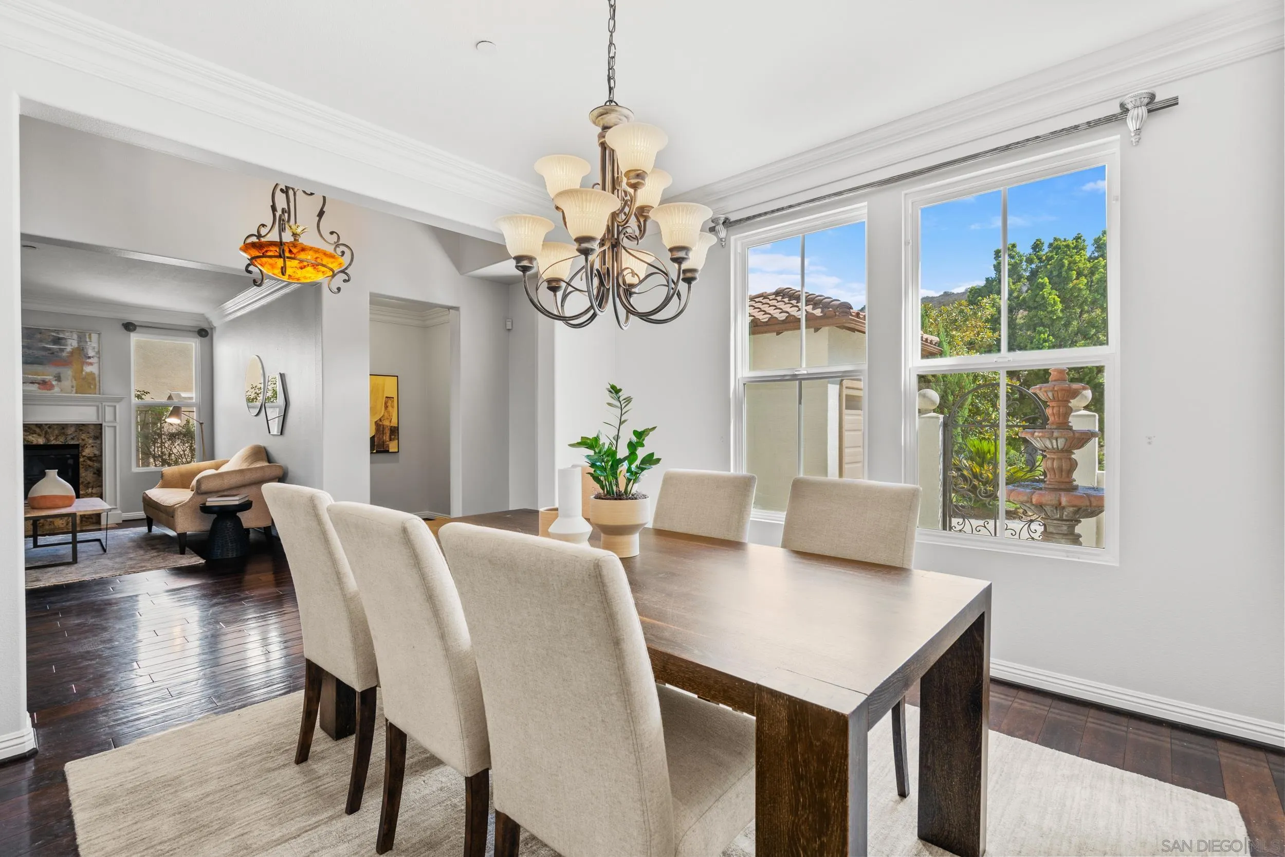 16174 Cayenne Ridge Road San Diego, CA 92127 - Photo 16 of 52 a view of a dining room with furniture a chandelier and wooden floor
