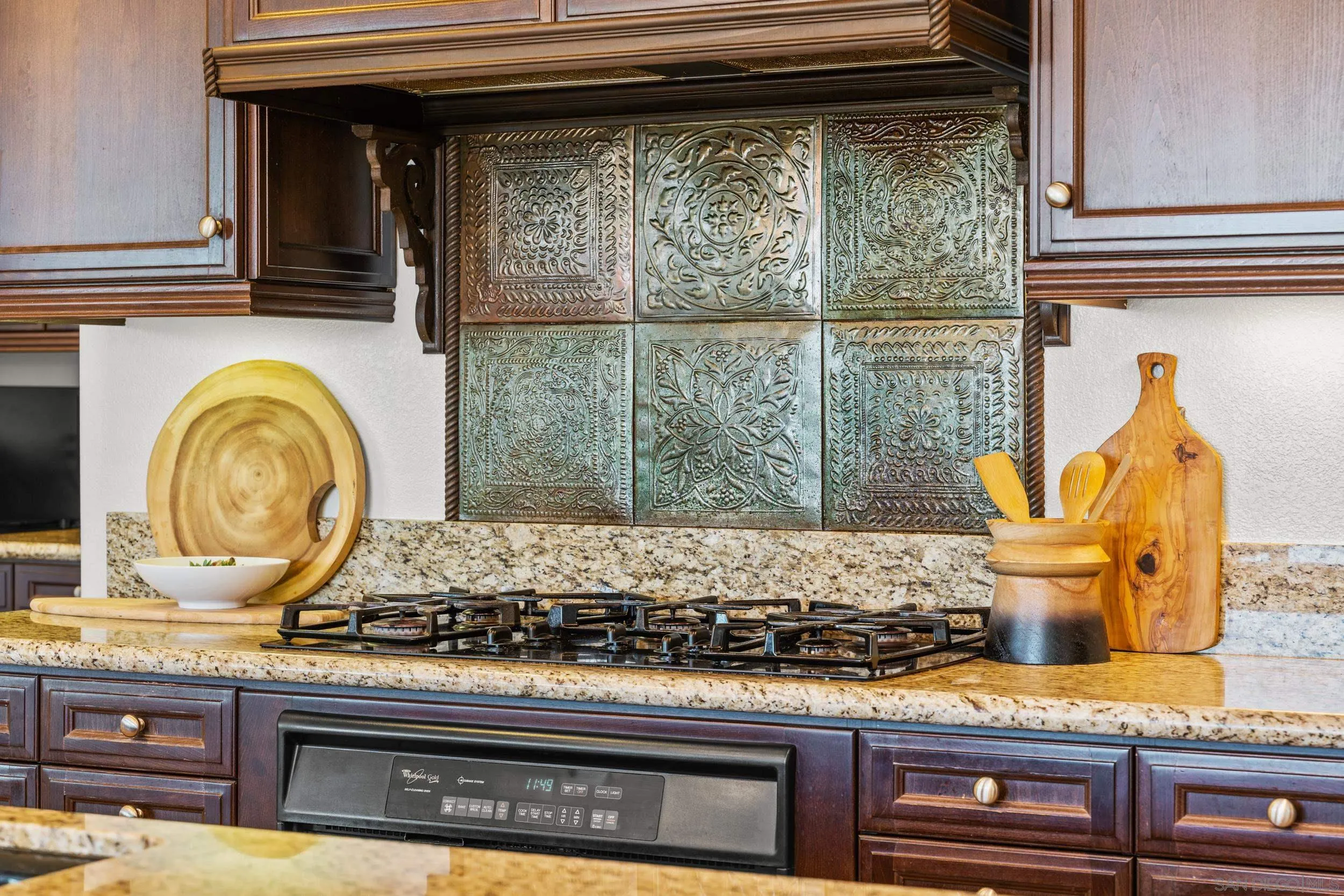 16174 Cayenne Ridge Road San Diego, CA 92127 - Photo 20 of 52 a kitchen with stove and cabinets