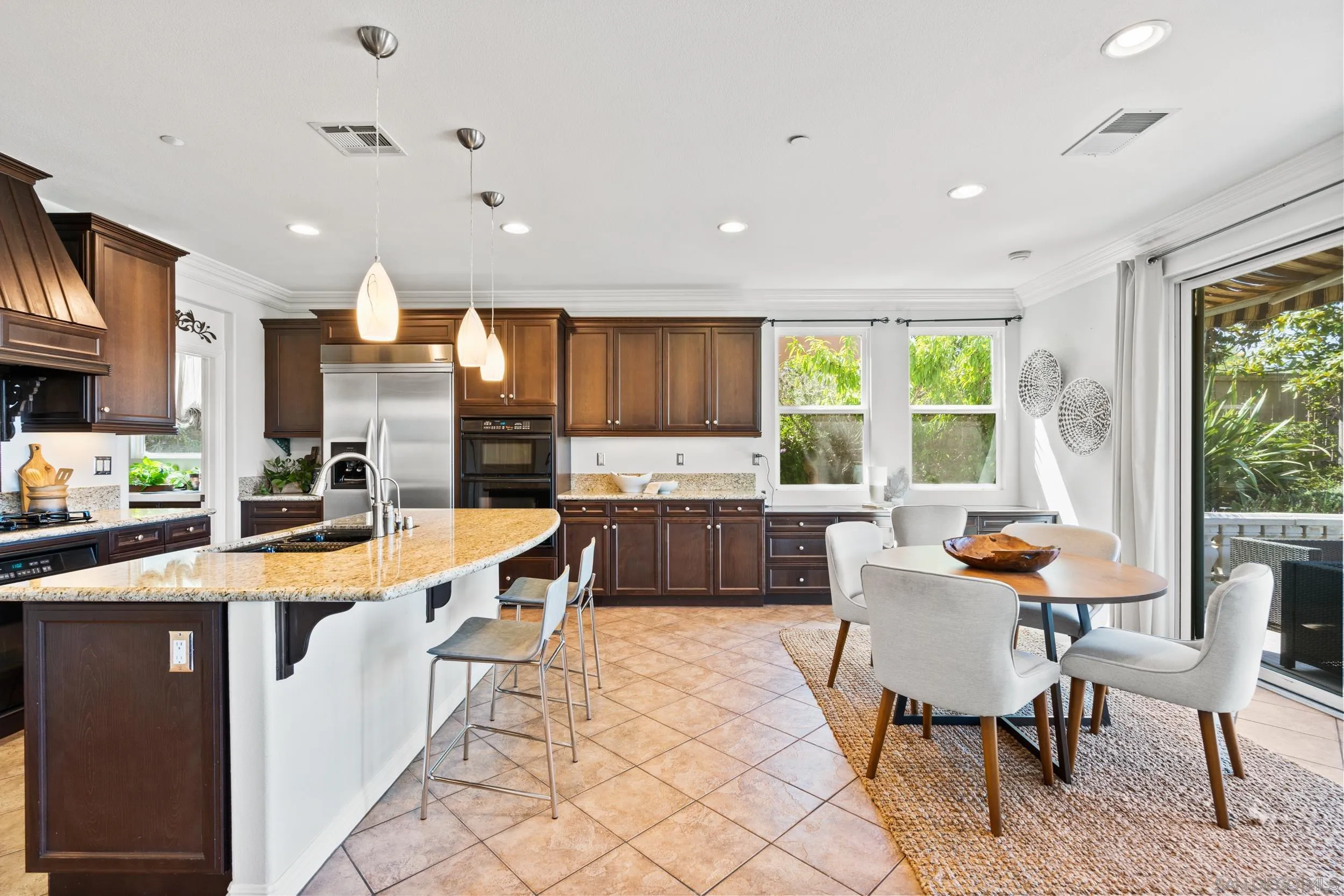 16174 Cayenne Ridge Road San Diego, CA 92127 - Photo 21 of 52 a kitchen with stainless steel appliances granite countertop a stove a sink a refrigerator and a dining table
