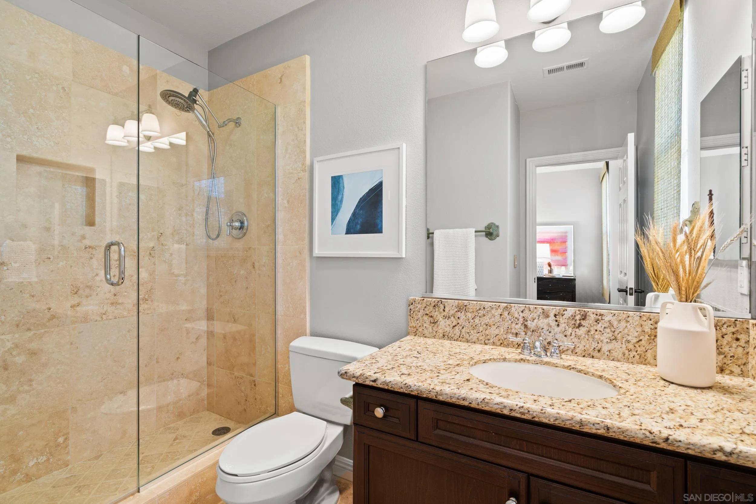 16174 Cayenne Ridge Road San Diego, CA 92127 - Photo 31 of 52 a bathroom with a granite countertop sink a toilet and shower