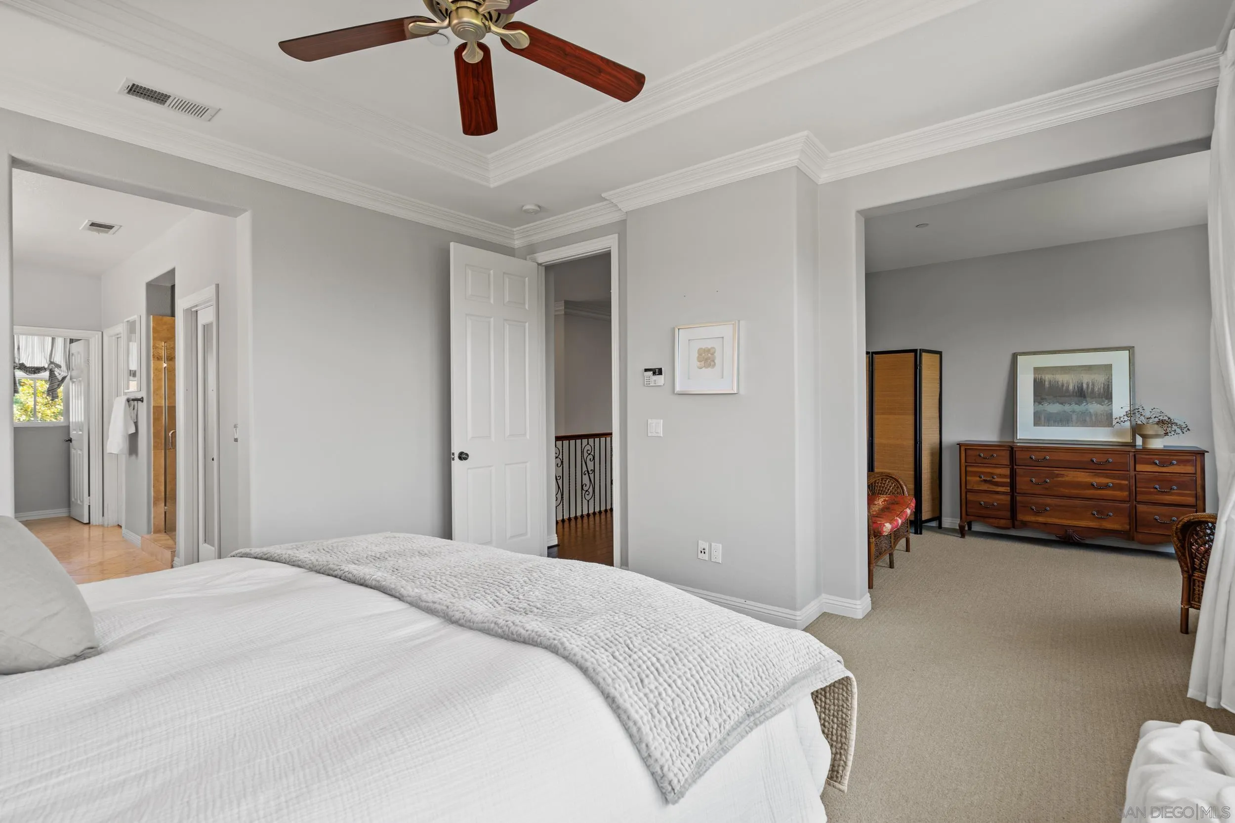 16174 Cayenne Ridge Road San Diego, CA 92127 - Photo 37 of 52 a bedroom with a bed and a chandelier