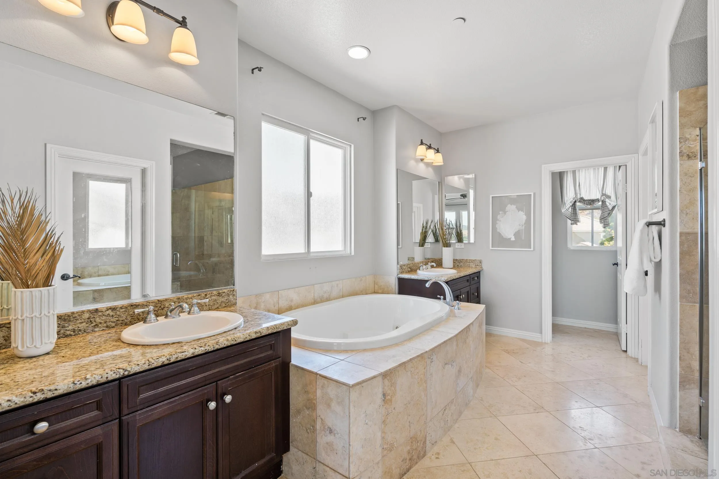 16174 Cayenne Ridge Road San Diego, CA 92127 - Photo 40 of 52 a spacious bathroom with a sink double vanity and a mirror