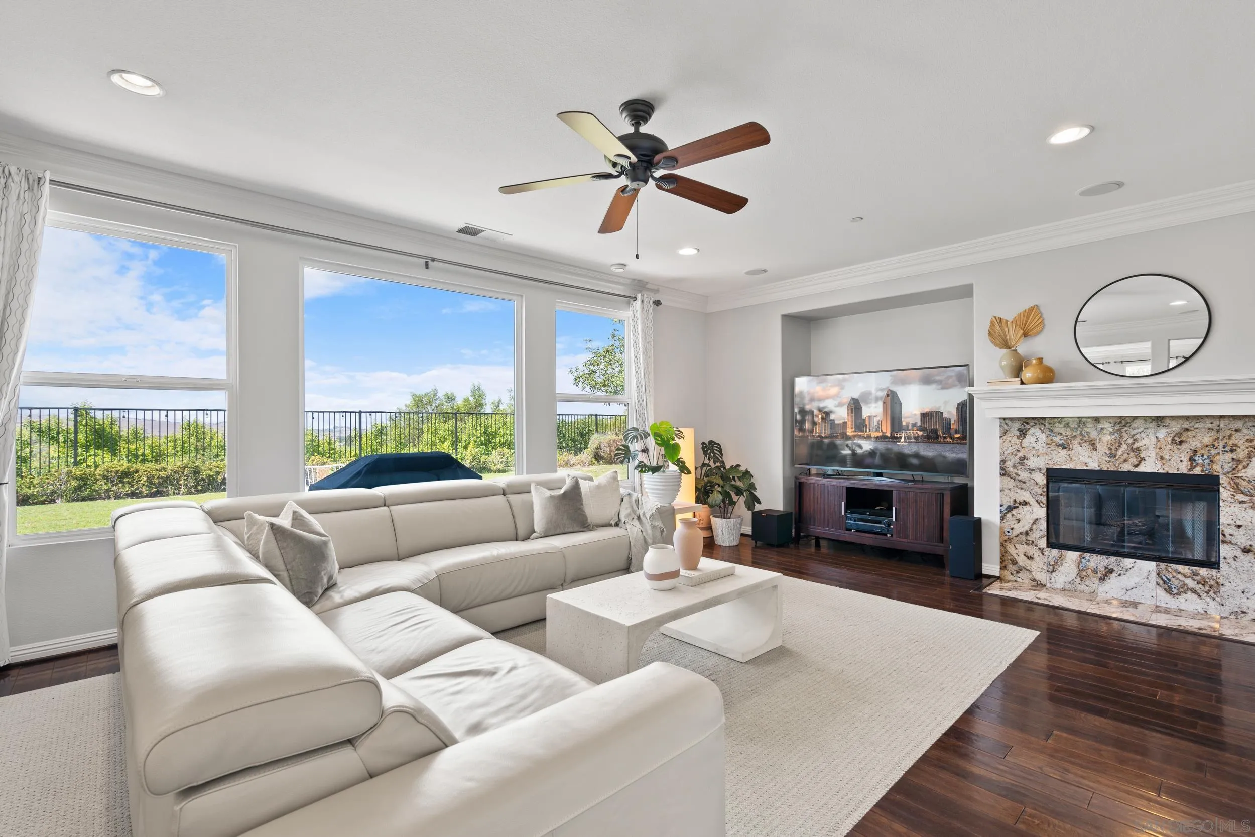 16174 Cayenne Ridge Road San Diego, CA 92127 - Photo 5 of 52 a living room with furniture a fireplace and a large window