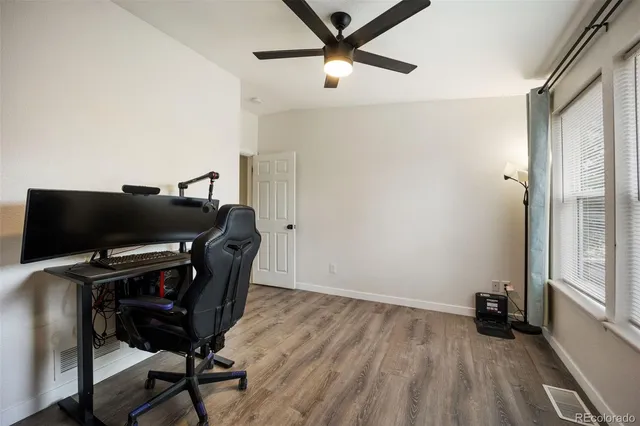 a view of a workspace with furniture and a window