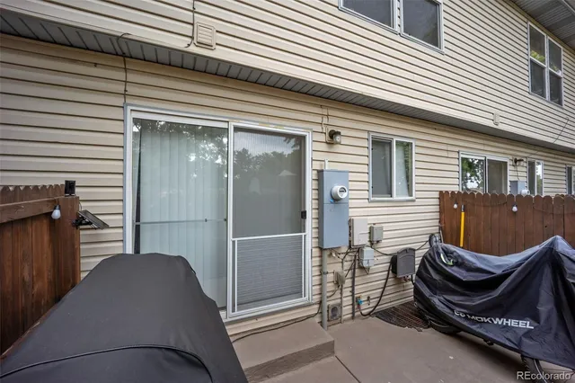 a balcony with a bench and a barbeque