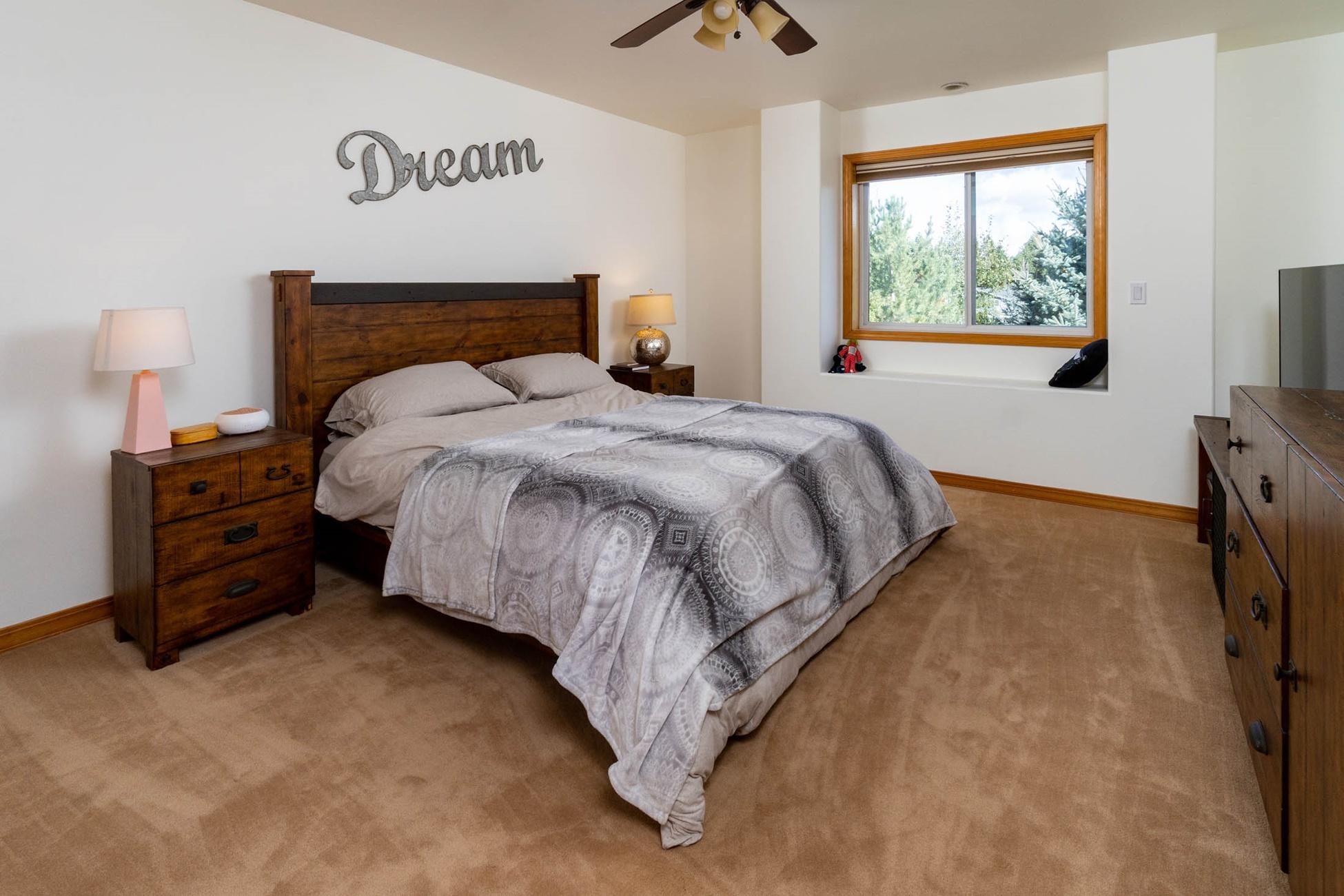 61899 Dobbin Court Bend, OR 97702 - Photo 14 of 26 a bed sitting in a bedroom next to a window