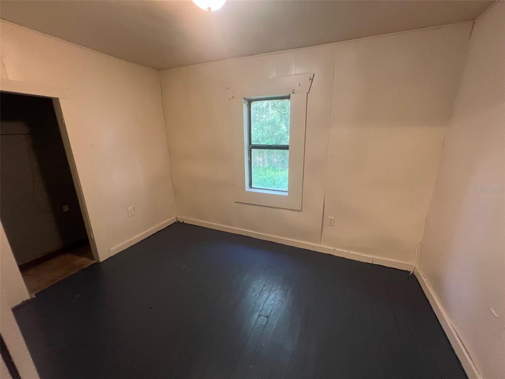 1290 Henson Lane, Unit 1 Bartow, FL 33830 - Photo 3 of 12 an empty room with wooden floor and windows