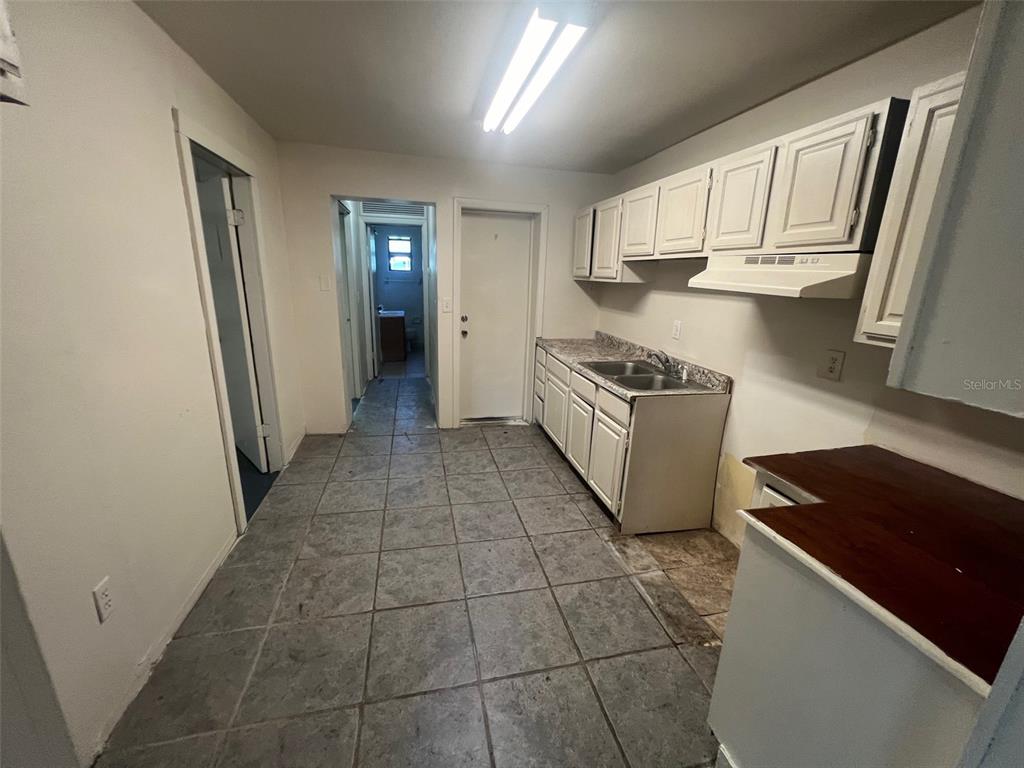 1290 Henson Lane, Unit 1 Bartow, FL 33830 - Photo 8 of 12 a kitchen with granite countertop a refrigerator and a stove top oven