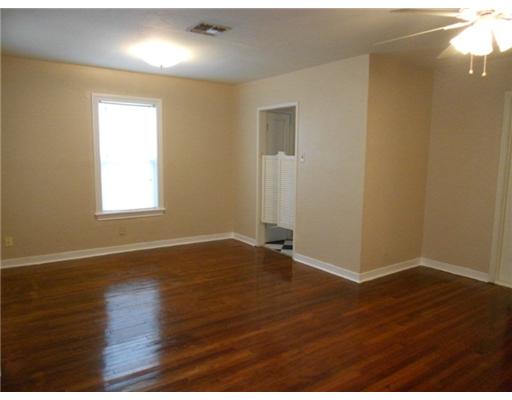 713 Ralston Avenue Corpus Christi, TX 78404 - Photo 2 of 10 an empty room with wooden floor and windows