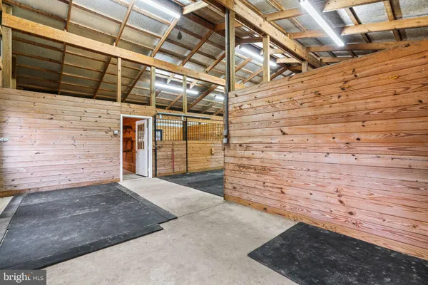 an empty room with a window and a kitchen