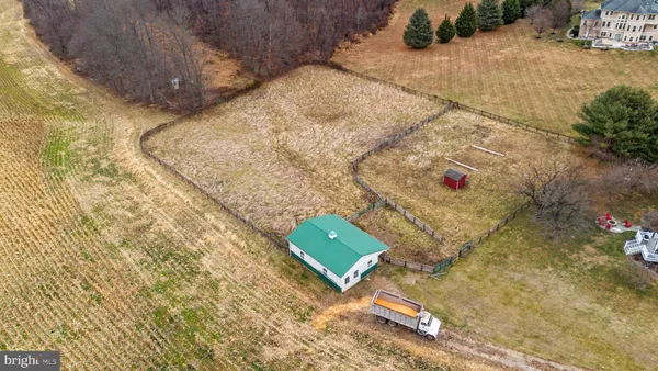 a view of an empty room with a window and kitchen view