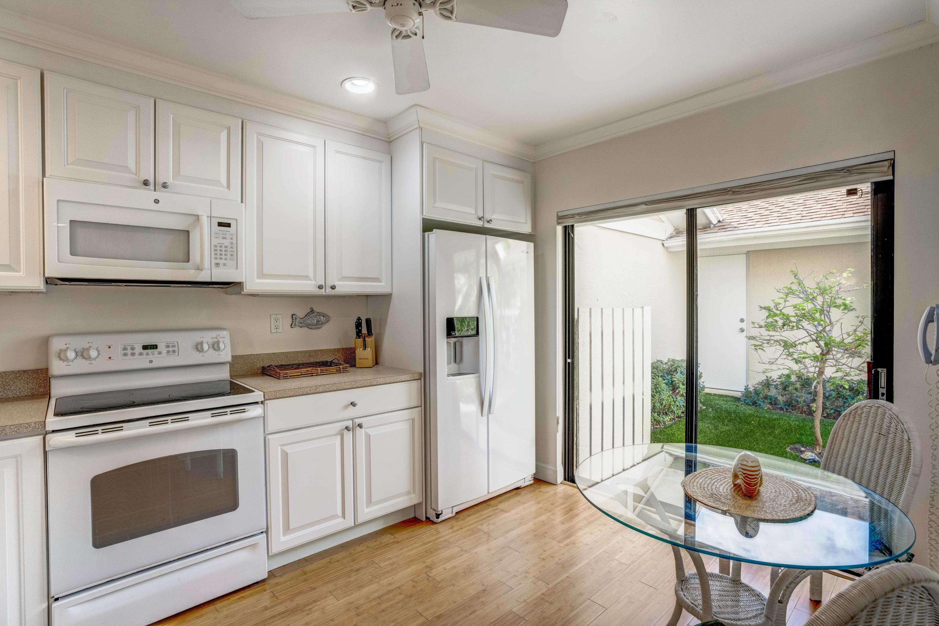 3673 Cape Pointe Circle Jupiter, FL 33477 - Photo 23 of 37 Kitchen Looking into courtyard