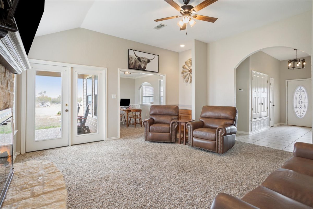 8600 Five Wells Road Rogers, TX 76569 - Photo 31 of 40 a living room with furniture and a chandelier