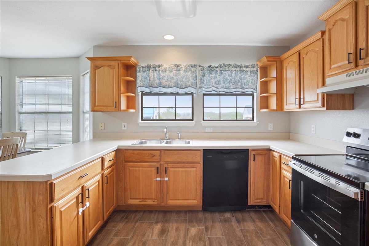 8600 Five Wells Road Rogers, TX 76569 - Photo 34 of 40 a kitchen with a sink stove and cabinets