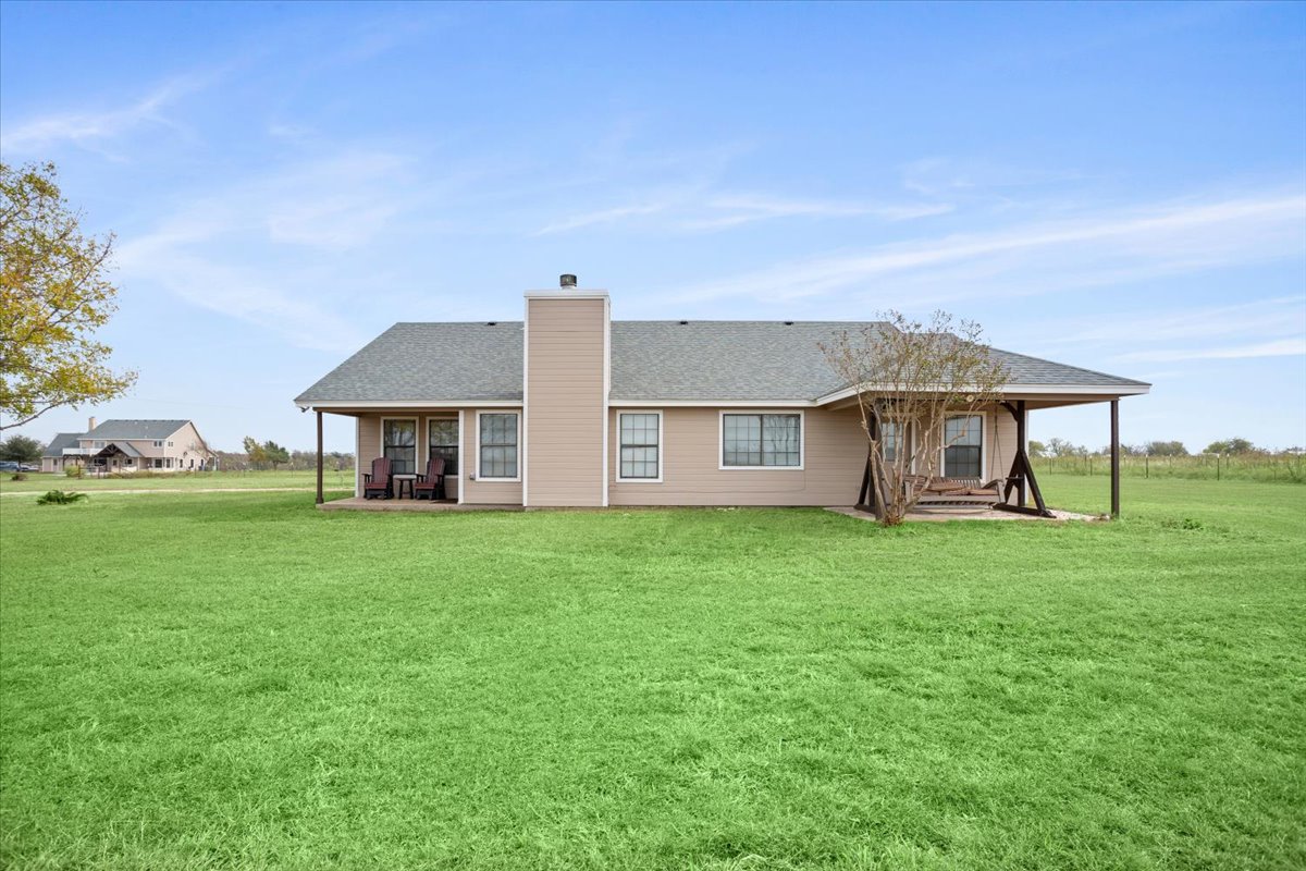 8600 Five Wells Road Rogers, TX 76569 - Photo 37 of 40 a view of a house with backyard and garden