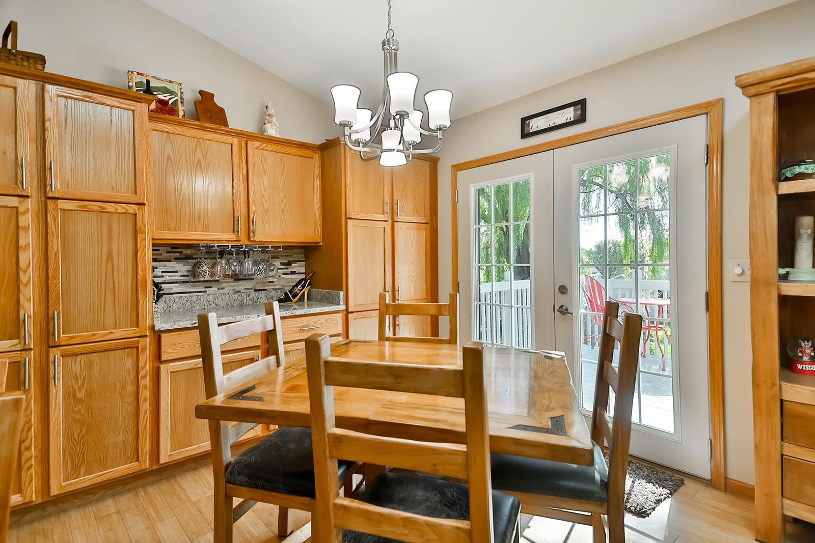 245 Rochester Road Northeast Poplar Grove, IL 61065 - Photo 11 of 29 a view of a dining room with furniture a chandelier and large window