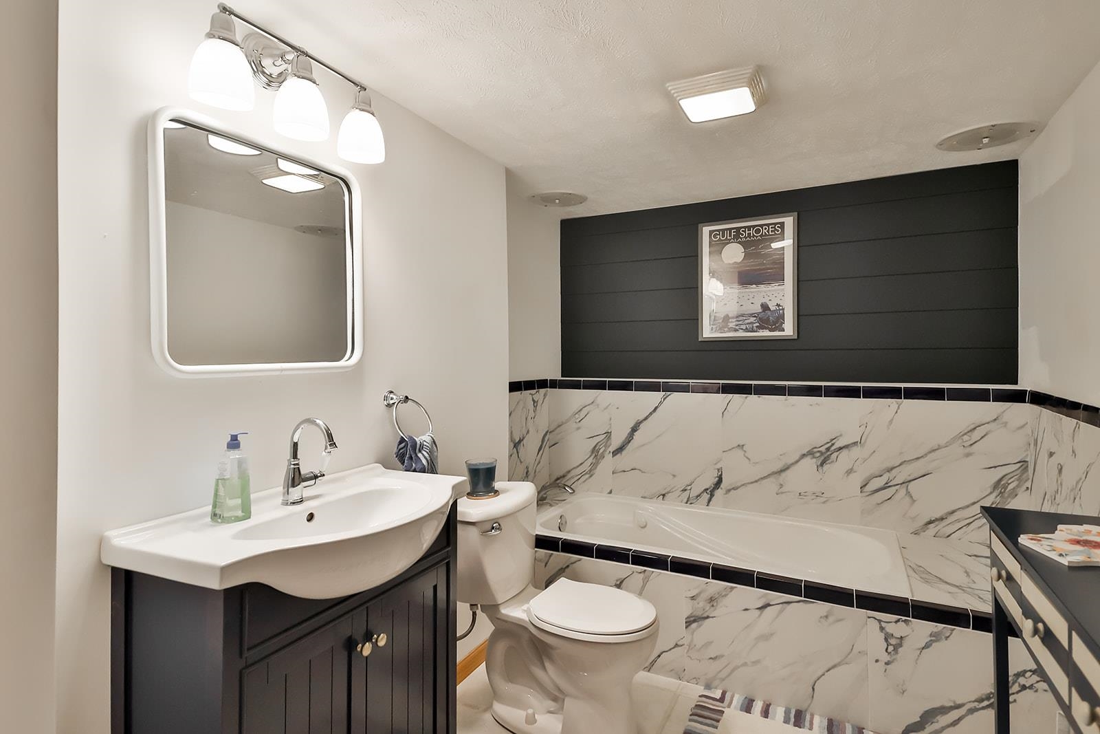 245 Rochester Road Northeast Poplar Grove, IL 61065 - Photo 23 of 29 a bathroom with a toilet sink and mirror